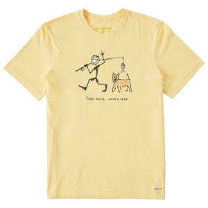 Yellow T-shirt with a simple drawing of a stick figure fishing alongside a dog and the phrase \“fish more, worry less.\“