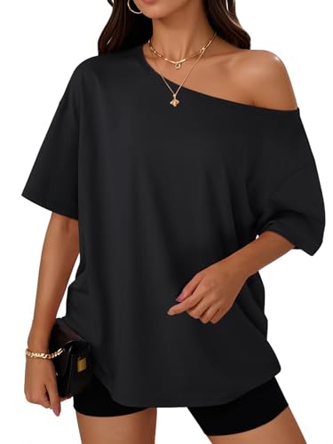A woman is wearing an off-the-shoulder short-sleeve black top paired with black shorts. She accessorizes with gold necklaces, hoop earrings, and a bracelet, and is holding a small black clutch.