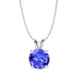A silver chain necklace features a round-cut blue gemstone set in a four-prong setting.