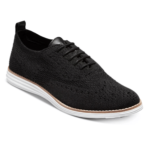 A black knit wingtip oxford shoe featuring a breathable upper, lace-up closure, and a white cushioned sole for comfort.