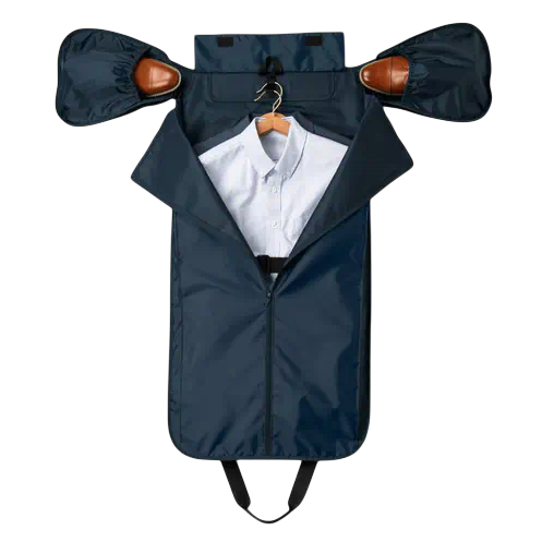 A travel garment bag in dark blue, displayed open with a shirt on a hanger inside, and shoes stowed in side compartments.