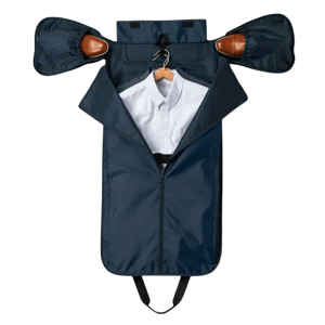 A travel garment bag in dark blue, displayed open with a shirt on a hanger inside, and shoes stowed in side compartments.