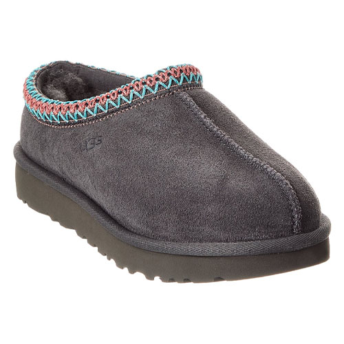 A gray slip-on shoe with a zigzag trim in teal and pink, featuring a cozy interior and a thick sole.