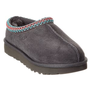 A gray slip-on shoe with a zigzag trim in teal and pink, featuring a cozy interior and a thick sole.