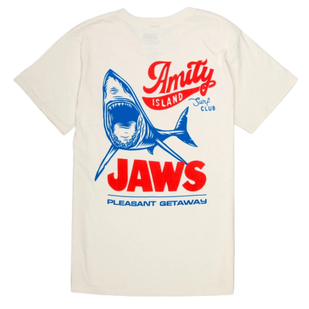 A white T-shirt featuring a blue and red graphic of a shark with the words \“Amity Island Surf Club,\“ \“JAWS,\“ and \“Pleasant Getaway.\“