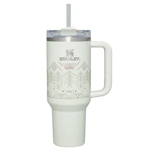 Stanley insulated travel mug with a handle, lid, straw, and geometric design.