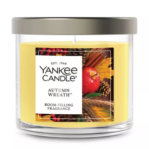 Yankee Candle Autumn Wreath, featuring a room-filling fragrance with an autumn-themed label showing apples, leaves, and cinnamon.