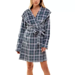 A person wearing a plaid bathrobe with a shawl collar and a tie belt.