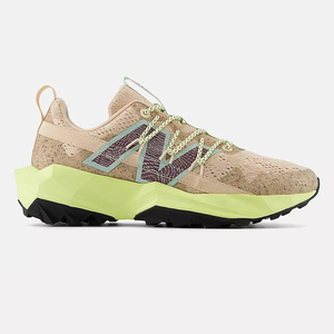 A beige sneaker with green accents and a chunky, angular sole.