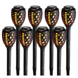 8-piece set of black solar-powered yard lights with a basket weave design, featuring warm LED lights that mimic flickering flames.