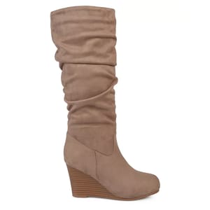 A slouchy, tan-colored mid-calf boot with a wedge heel.