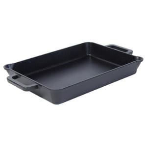 A rectangular black cast-iron baker with two side handles, featuring a smooth, slightly rounded interior suitable for baking or roasting.