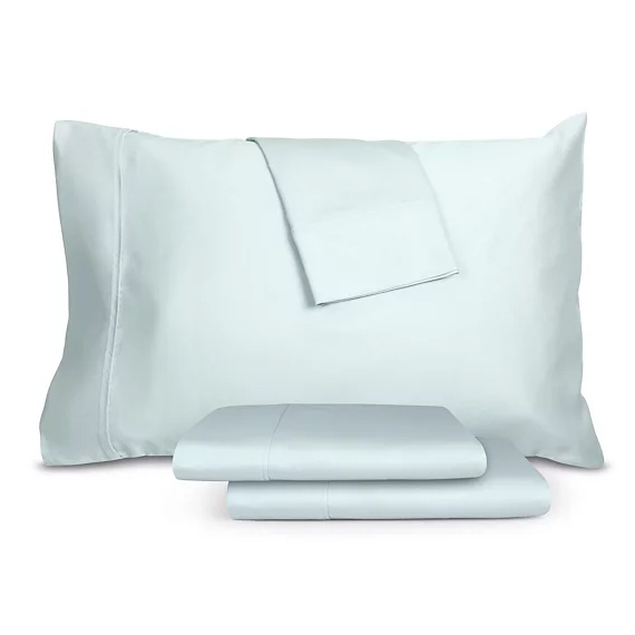 1,200 thread count cotton-blend sheet set in a light blue color, featuring a large pillowcase, stacked folded sheets, and an additional smaller folded sheet on top.
