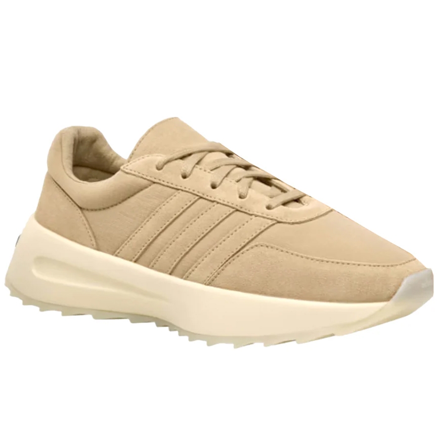 A beige sneaker with a minimalist design, featuring a cushioned sole and subtle stitching details.