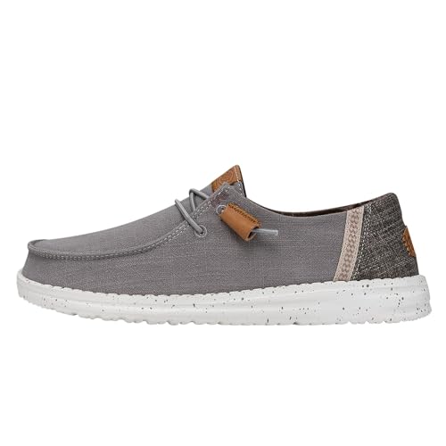 A casual grey shoe with a speckled white sole and simple laces, featuring brown accents and a textured heel.