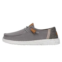 A casual grey shoe with a speckled white sole and simple laces, featuring brown accents and a textured heel.