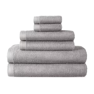 A stack of five gray towels in varying sizes, from washcloth to bath towel.