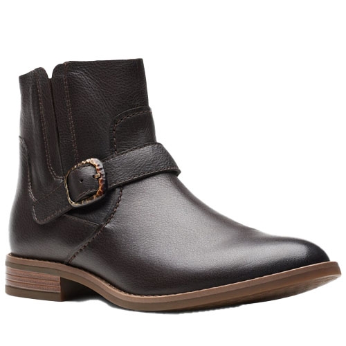 A dark brown leather ankle boot with a side buckle and elastic panels, featuring a low wooden heel and a sleek, streamlined design.