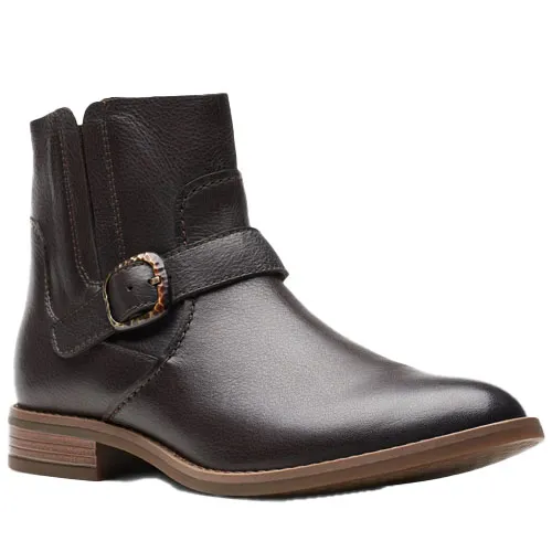 A dark brown leather ankle boot with a side buckle and elastic panels, featuring a low wooden heel and a sleek, streamlined design.