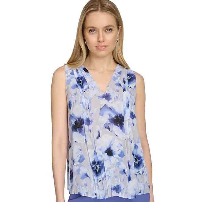 Calvin Klein Sleeveless Pleated Top features a V-neck with a blue floral pattern on a white background, showcasing delicate pleats that add texture and flow.