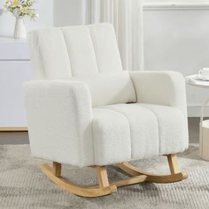 White modern rocking chair with soft upholstery and light wooden rockers, placed on a textured rug beside a small round table and a floral vase.