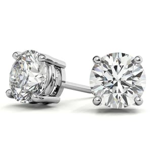 Lab-grown diamond studs featuring round-cut stones set in a four-prong white metal setting, offering a classic and elegant look.