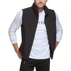 Calvin Klein Stretch Soft Shell Vest features a sleek, black design with a high collar, zippered front, and chest pocket. It's worn over a white long-sleeve shirt, offering a modern and versatile layering option.