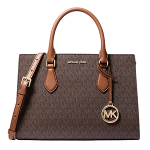 A Michael Kors brown handbag with the \“MK\“ logo pattern and gold-tone hardware, featuring dual handles and a detachable shoulder strap.