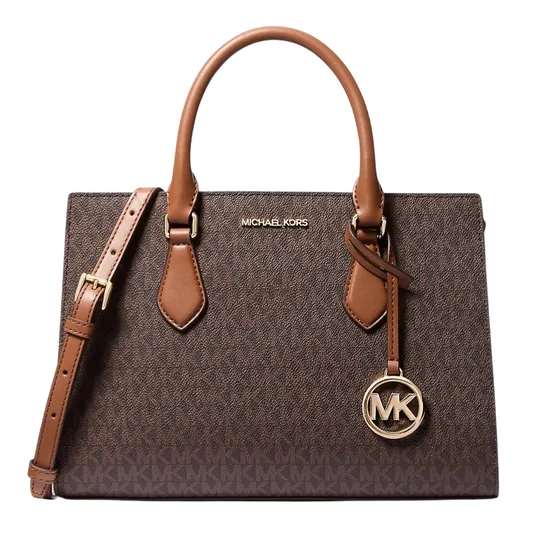 A Michael Kors brown handbag with the \“MK\“ logo pattern and gold-tone hardware, featuring dual handles and a detachable shoulder strap.