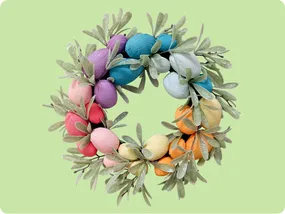 A colorful wreath featuring pastel-hued egg-shaped elements and green leaves, set against a light green background, ideal for spring or Easter decorations.