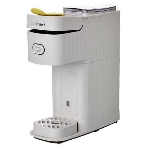 A compact white Cuisinart coffee maker with a brew/cancel button, designed for single servings, featuring a sleek design with a drip tray and a top compartment for water or coffee pods.