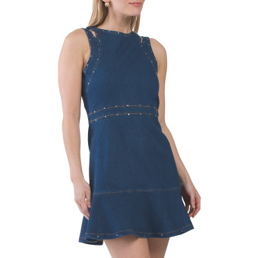 Sleeveless denim dress with a fitted bodice and a flounce skirt, featuring subtle stud embellishments along the seams.