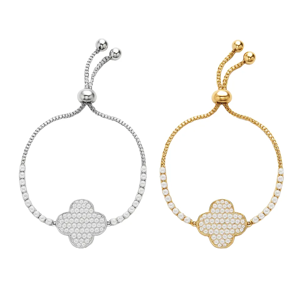 Two adjustable bracelets, one in silver and the other in gold, feature a central clover-shaped charm encrusted with clear crystals, connected by a beaded chain.