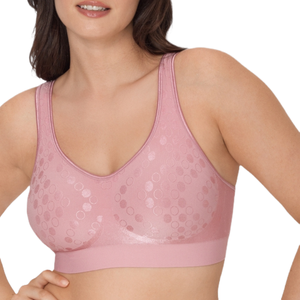 A soft pink, wireless, seamless bra featuring a v-neckline and a textured circular pattern for comfort and flexibility.