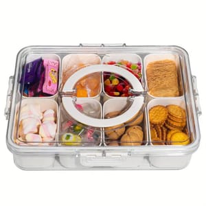 A clear storage box with assorted candies, cookies, and snacks in separate compartments.