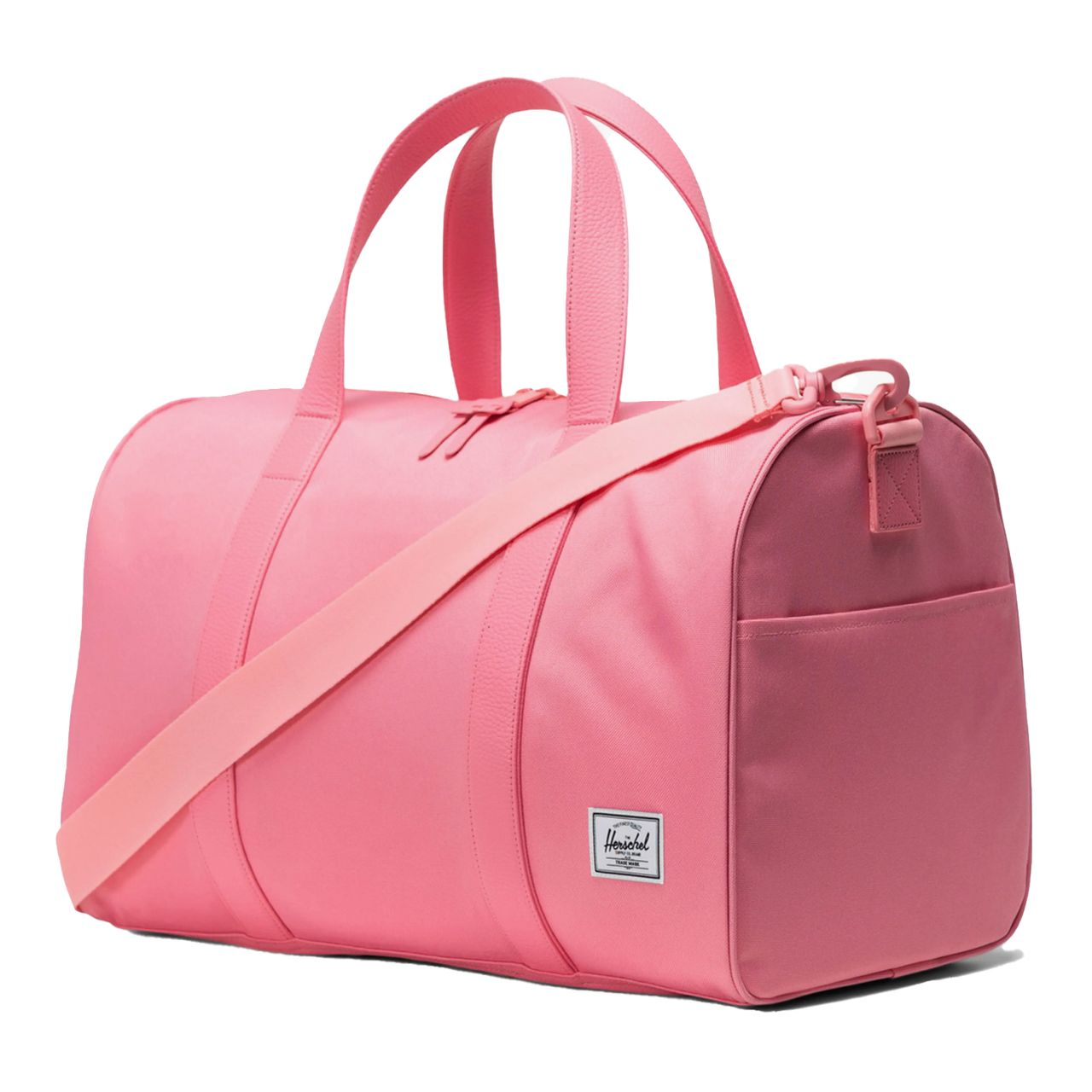 Pink duffel bag with a shoulder strap and dual handles, featuring a small front pocket and a logo patch on the side.