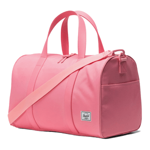 Pink duffel bag with a shoulder strap and dual handles, featuring a small front pocket and a logo patch on the side.