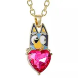 A necklace featuring a colorful cartoon dog pendant with blue accents, holding a large red heart-shaped gem, attached to a gold-toned chain.