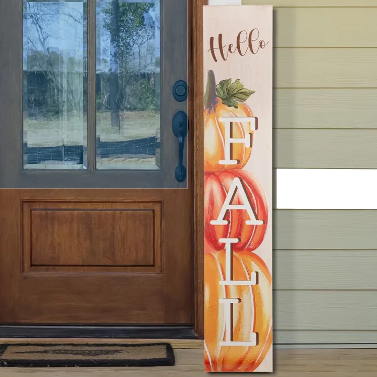 A decorative vertical sign with \“Hello Fall\“ and an illustration of pumpkins, displayed beside a front door.