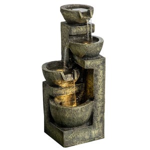 A cascading tiered fountain with a stacked bowl design and a stone-like finish features water flowing from top to bottom, creating a relaxing water sound.
