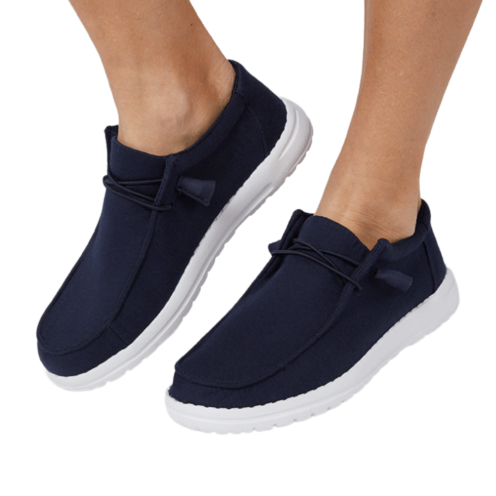 Navy blue slip-on shoes with white soles and minimalist design, featuring elastic laces for easy wear.