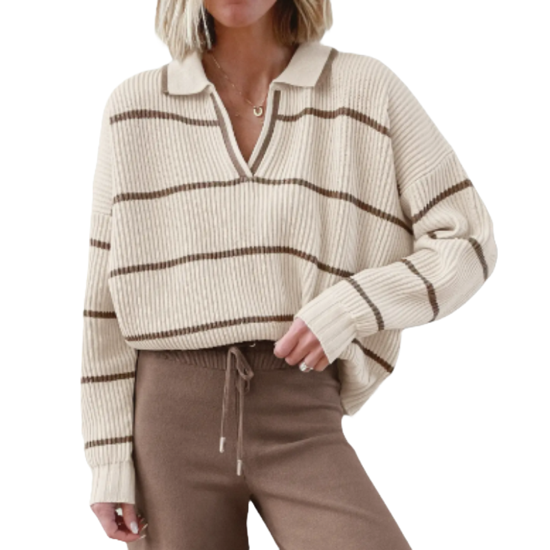 A woman is wearing a beige, ribbed knit sweater with brown horizontal stripes and a collar, paired with brown drawstring pants.