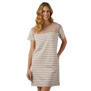 A woman wears a beige and white striped short-sleeve dress with a round neckline.