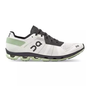 On Running Cloudflash 2 Shoes feature a sleek design with a white and black color scheme, highlighted by a green accent at the heel. They showcase the brand's signature CloudTec cushioning technology for enhanced performance.
