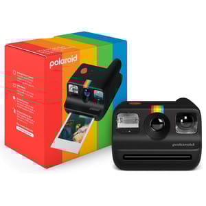 A Polaroid Go instant camera with a black body and rainbow stripe is displayed next to its colorful packaging. The camera is shown ejecting an instant photo.