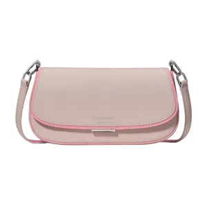 A light pink Kate Spade shoulder bag with a darker pink trim and a silver metal buckle. The bag features a pebbled leather texture and has a removable strap with silver-tone hardware.