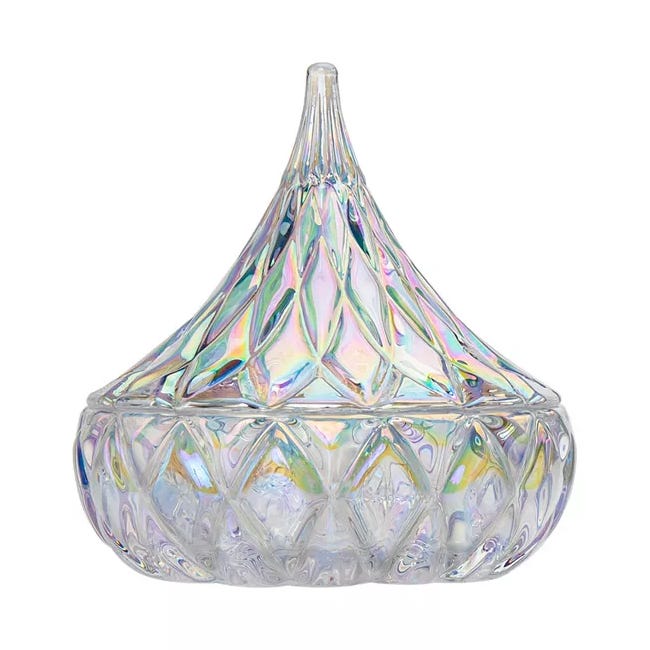 Iridescent glass container with a diamond pattern and a pointed lid, designed for storing small items or decorative purposes.