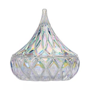 Iridescent glass container with a diamond pattern and a pointed lid, designed for storing small items or decorative purposes.