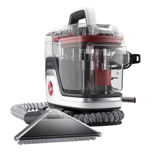 This is a compact Hoover carpet cleaner featuring a clear tank design with red accents, a flexible hose, a sturdy handle, and a triangular cleaning attachment for targeted cleaning.