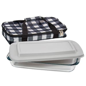 A glass casserole dish with a snap-on lid is shown alongside a black and white checkered insulated carrying case with handles and a zipper closure.